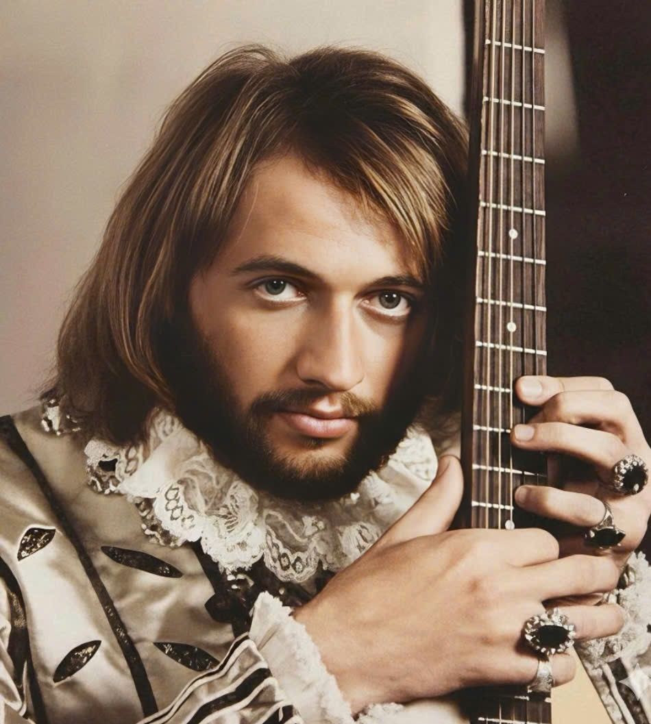 The Tragic Final Days of Maurice Gibb: The Quiet Genius of the Bee Gees Whose Sudden Death Shattered Millions. No one could have predicted the heartbreak that awaited the Bee Gees in 2003. Maurice Gibb, the gentle, unassuming heartbeat of the legendary group, appeared vibrant and full of life—until a sudden, unforeseen medical crisis struck. What began as ordinary abdominal discomfort escalated into a critical emergency, culminating in surgery, cardiac arrest, and his shocking passing at just 53. The world watched in stunned silence as Barry and Robin lost their brother, their creative partner, and their closest friend. Fans everywhere mourned a talent that had quietly shaped the sound of an era. This is the poignant story of Maurice Gibb’s final days, the grief that followed, and the indelible mark he left on music and hearts around the globe.