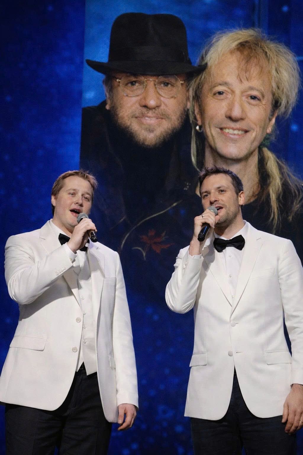 “TWO SONS. ONE SONG. AND A LEGACY FINALLY ALLOWED TO BREATHE Adam Gibb and Robin John Gibb stood side by side — two sons carrying the weight of Bee Gees history — to record one single song together. No grand announcement, no nostalgia tour. Just their voices blending in quiet harmony, breathing fresh life into the unfinished melody their fathers left behind. In that intimate moment, Maurice and Robin’s spirit felt present again, as the next generation turned silence into living legacy.”